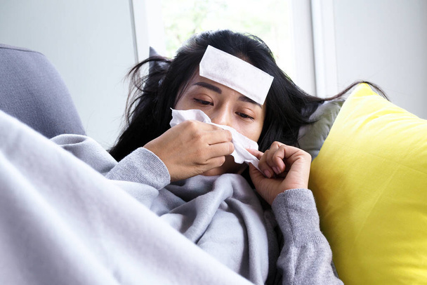 Las mujeres asiáticas tienen fiebre alta y secreción nasal. concepto de enfermos - Foto, Imagen