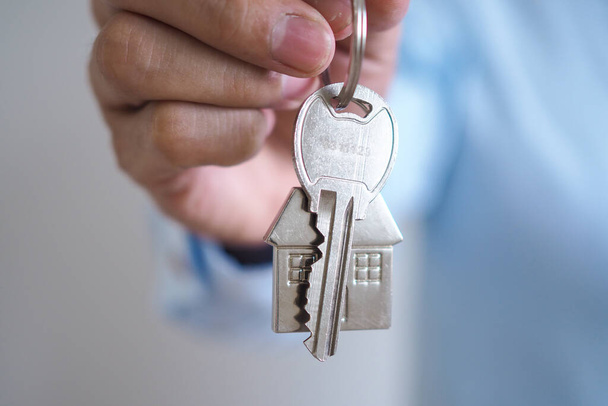 Landlord unlocks the house key for new home - Photo, Image