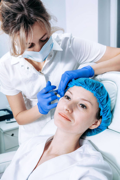 doctor cosmetologist makes Rejuvenating Biorevitalization facial injections procedure on female skin in beauty salon - Φωτογραφία, εικόνα