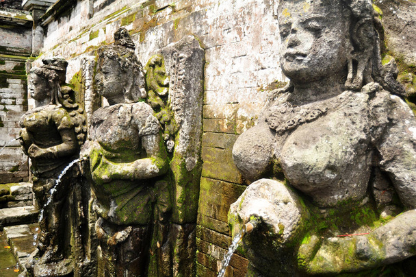 Bathing temple figures or holy water fountain of Goa Gajah or Elephant Cave significant Hindu archaeological site for travelers people travel visit and respect at Ubud city town in Bali, Indonesia - 写真・画像