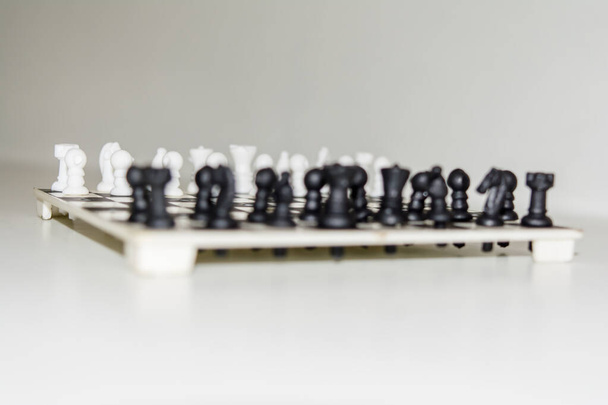 Chess board with figures on isolate white background. - Photo, image