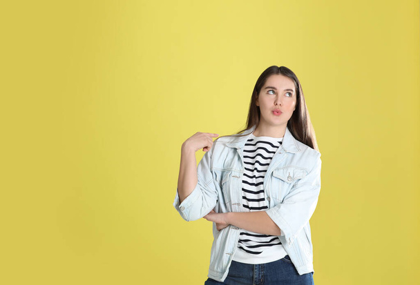 Portrait of young woman on yellow background. Space for text - Foto, imagen