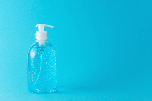 Hand sanitizer in a bottle on a bright background. Coronavirus prevention concept. - Photo, image