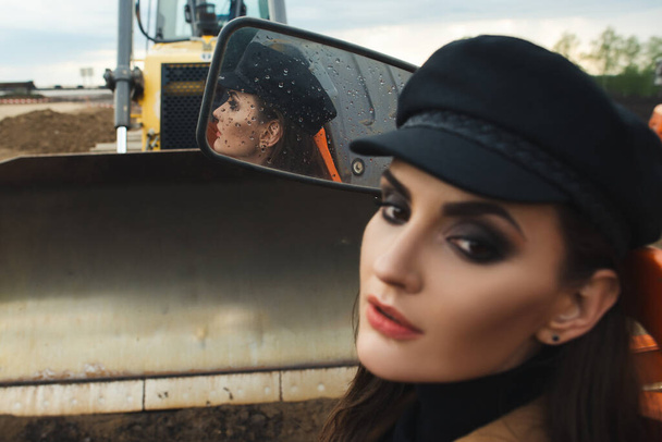 young woman posing near excavator - Photo, Image