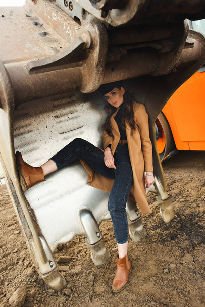 young woman posing near excavator - Photo, image