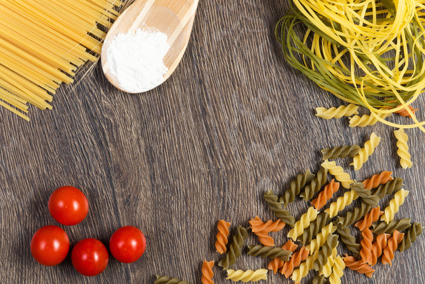 Pasta, tomatoes and flour - Photo, Image
