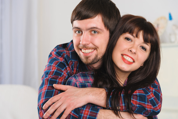 Portrait of young smiling couple at home interior - Фото, зображення