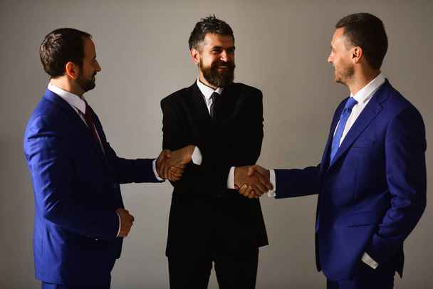 Businessmen wear smart suits and ties. Executives make deal - Fotó, kép