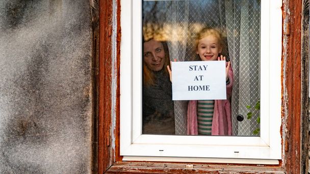 ホームセーフキャンペーン。幸せなヨーロッパの家族は隔離された自己隔離に残った。流行性コロナウイルスは19の責任意識的な決定をcovidした。ロックダウンをテーマにした背景 - 写真・画像