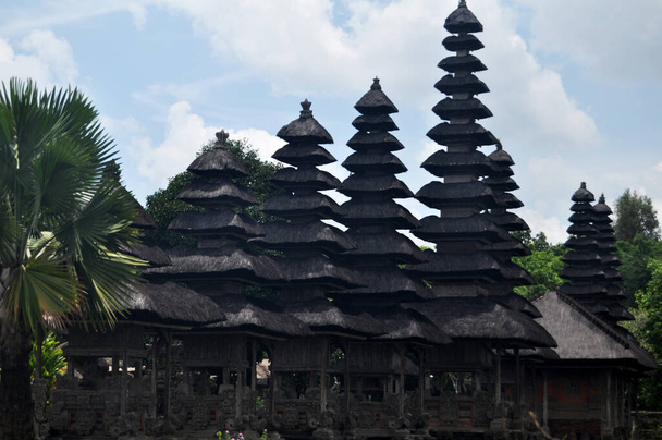 Ancient Meru towers of Pura Besakih temple significant Hindu archaeological site for travelers people travel visit and respect praying at Mount Agung city village in Bali, Indonesia - Photo, Image