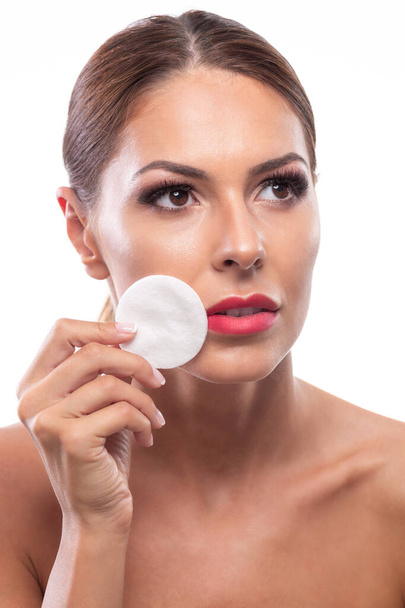 Healthy confident woman in process of makeup removal, makeup pad - Fotografie, Obrázek