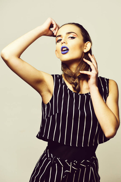 Pretty girl in striped suit with blue lips - Foto, Imagem