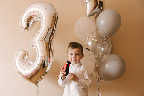 Cute boy 3 years old celebrating his birthday, photo of a child with balloons - Фото, изображение