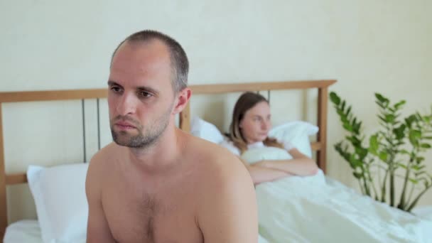 Upset man sitting in bed, sexual problems concept - Video, Çekim