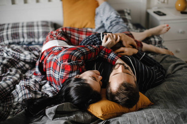 happy family cuddling at home in a stylish interior on the bed - Φωτογραφία, εικόνα