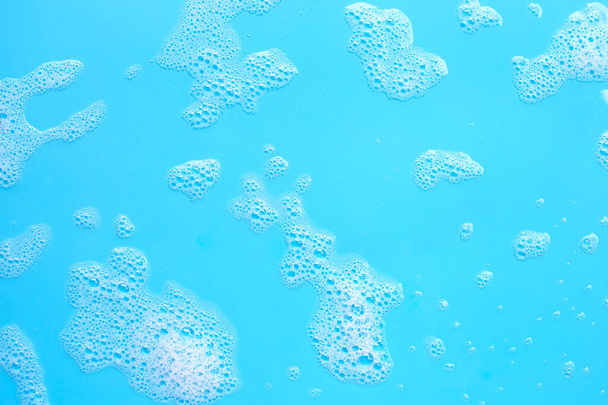 Foam on blue background. Top view - Photo, Image