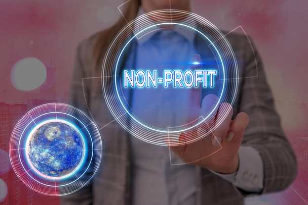 Conceptual hand writing showing Non Profit. Business photo showcasing type of organization that does not earn profits for its owners Elements of this image furnished by NASA. - Photo, Image