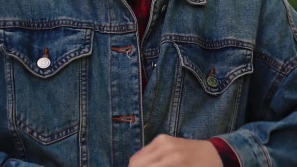 a girl buttons up a denim jacket - Footage, Video