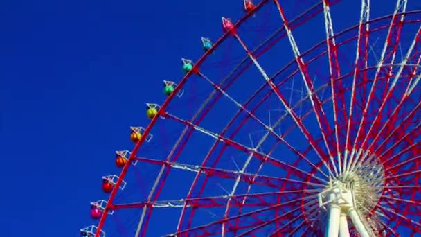A timelapse of ferris wheel at the amusement park in Odaiba Tokyo daytime long shot tilt - Footage, Video