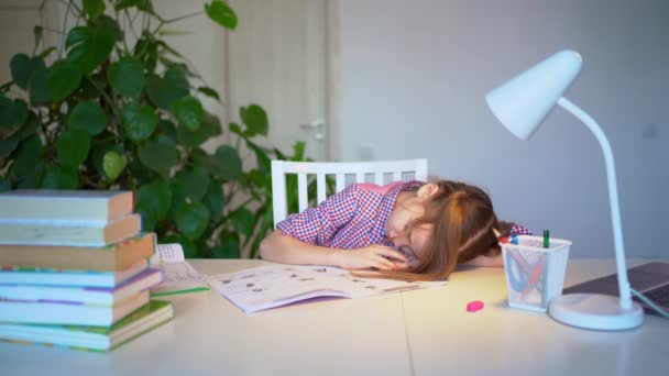 sleepy schoolgirl doing homework. studying at home. remote education - Záběry, video