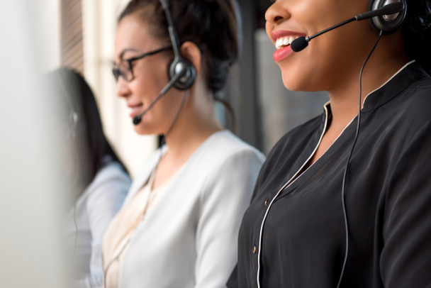 Mixed race women team working in call center as telemarketing customer service agents - Фото, изображение