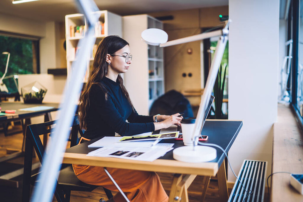 Millennial female copywriter typing text information during freelance work with web article for internet page, Caucasian smart casual hipster girl searching content during e learning on modern laptop - Zdjęcie, obraz