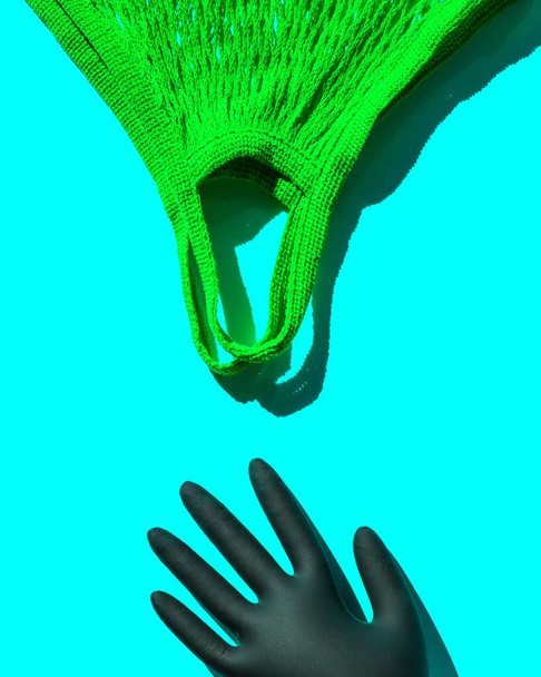 A reusable shopping bag and a hand in a black disposable glove. Pop art style. Top view. Place for text - Fotografie, Obrázek