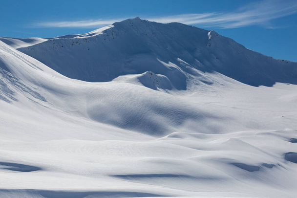 snowcapped Sandhubel mountain near Arosa in winter snowscape and blue sky - Photo, Image