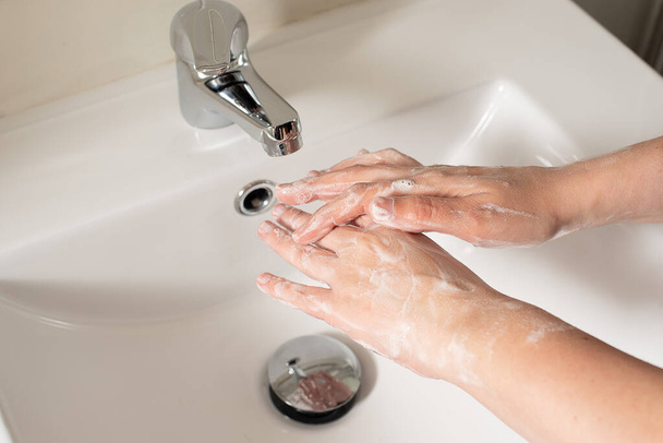 Woman washing hands at home - Foto, Imagem