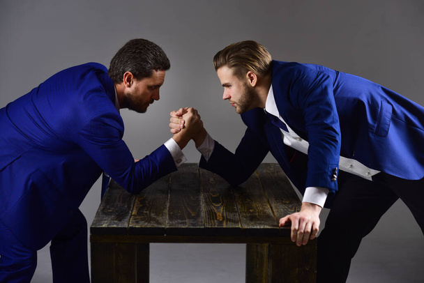 Men in suit or businessmen with tense faces compete - 写真・画像