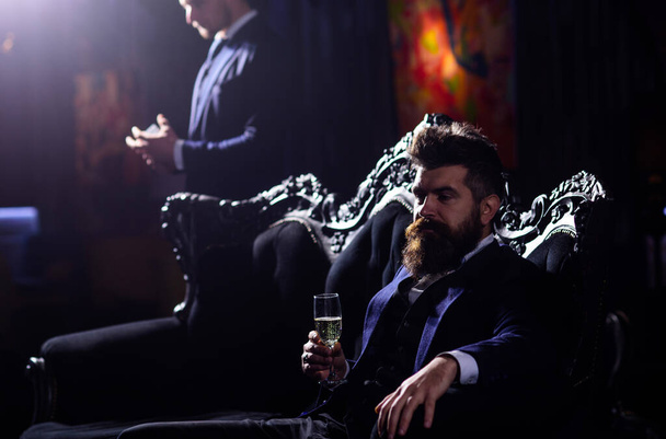 rich businessman sitting on sofa. Handsome luxury man spending time in mens club. - Фото, зображення