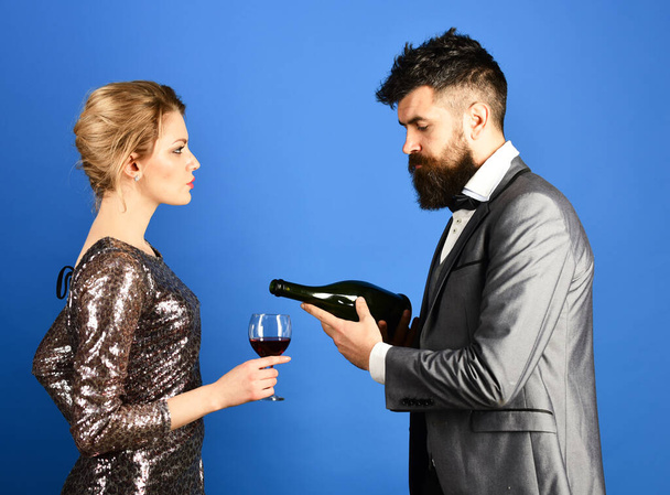 Winetasting and celebrating concept. Man with beard, woman in dress - Fotó, kép