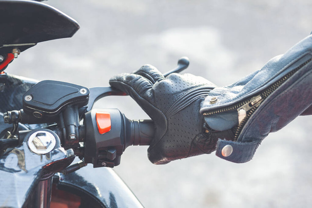 Closeup hand of man driving a motorbike on natural background - Photo, Image