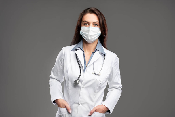 Female doctor with hands in pockets - Photo, image
