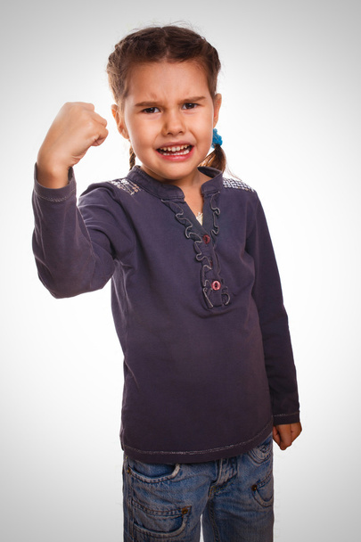 Evil girl shows fists experiencing anger and emotion - Foto, Bild