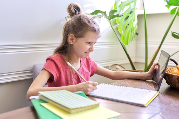 Girl child studying at home using digital tablet - Zdjęcie, obraz