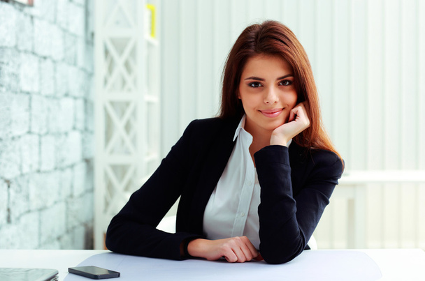 Businesswoman sitting at the table on her workplace - Photo, image