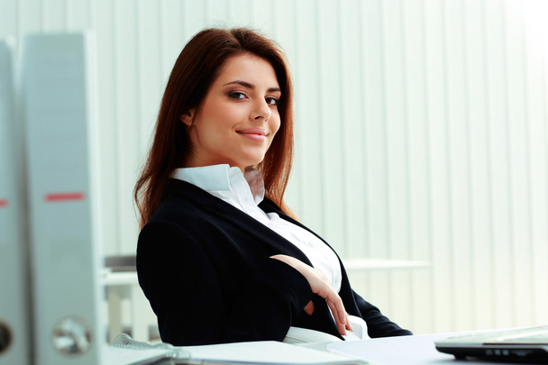 Businesswoman sitting at the table in office - Photo, image
