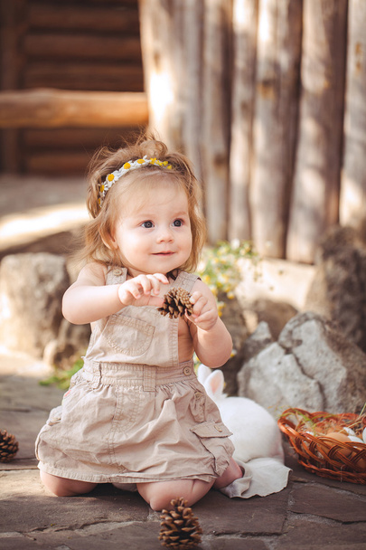 Little girl playing with rabbit in the village. Outdoor. Summer portrait. - Fotografie, Obrázek