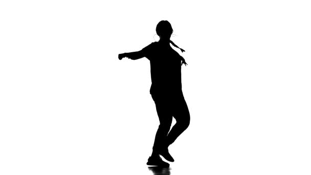 black silhouette on a white background, young beautiful girl dancer dancing hiphop, contemporary, modern street dance, slow motion - Video, Çekim