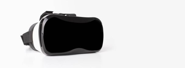VR virtual reality glasses half turned on light gray background. - Foto, afbeelding