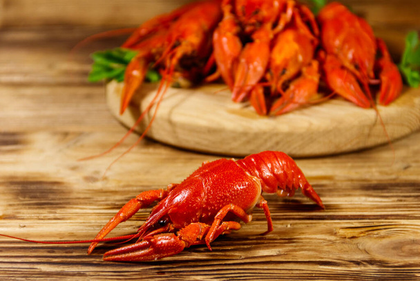 Boiled crayfish on cutting board on wooden table - Photo, Image