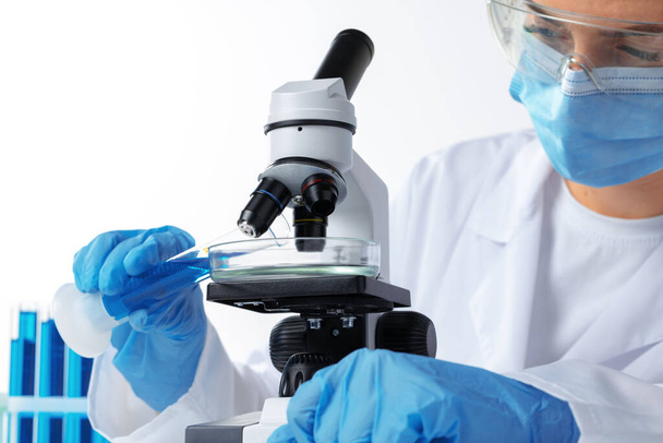 Scientists hands doing chemical research with the help of microscope - Zdjęcie, obraz