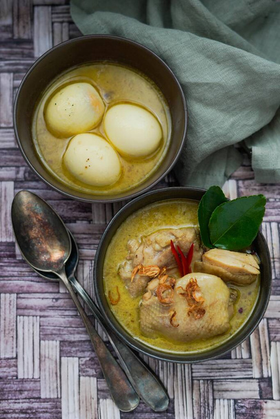 Opor Ayam (Indonesian Curry), Chicken and eggs cooked in coconut milk and spices and served to celebrate Idul Fitri / Lebaran  with steam rice  - Photo, Image