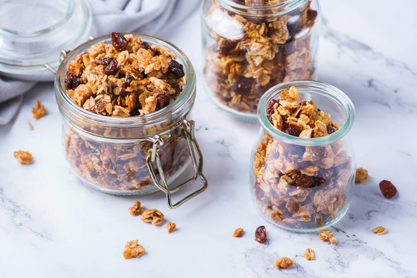 Healthy clean eating, dieting and nutrition, fitness, balanced food, breakfast concept. Homemade granola muesli with ingredients on a table - Photo, Image