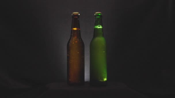 Bottle of cold beer on a black background - Кадри, відео