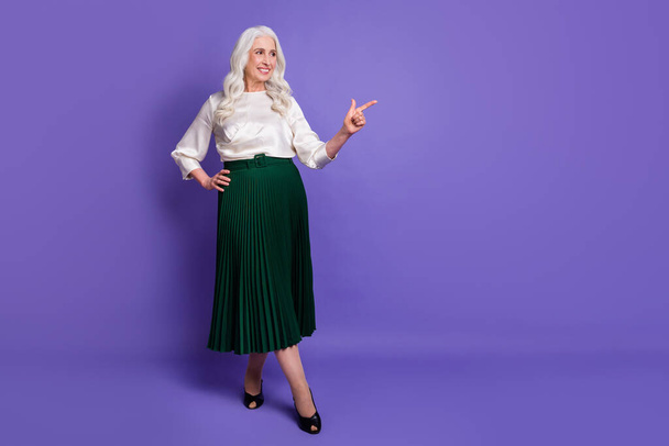 Full length body size view of her she nice attractive chic fashionable cheerful grey-haired woman showing ad copy space isolated on bright vivid shine vibrant lilac violet purple color background - Fotó, kép