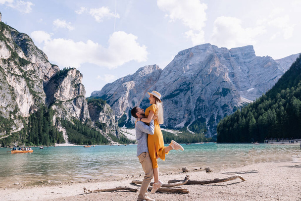 couple walk and have fun along the Lago di Braies in Italy. - Photo, Image