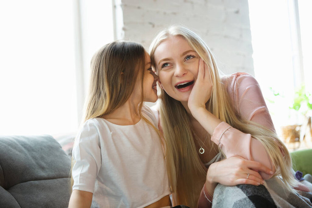 Mother and daughter, sisters have quite, beauty and fun day together at home. Comfort and togetherness. Telling a secrets, joking. - Zdjęcie, obraz