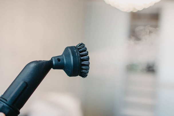 steam erupting from brush of steam cleaner for cleaning house - 写真・画像